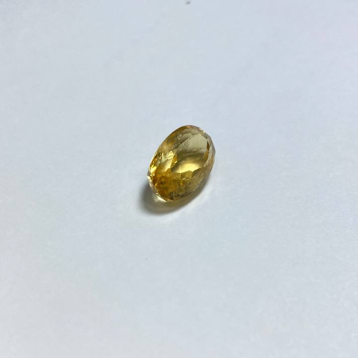 a large yellow gemstone on a white background