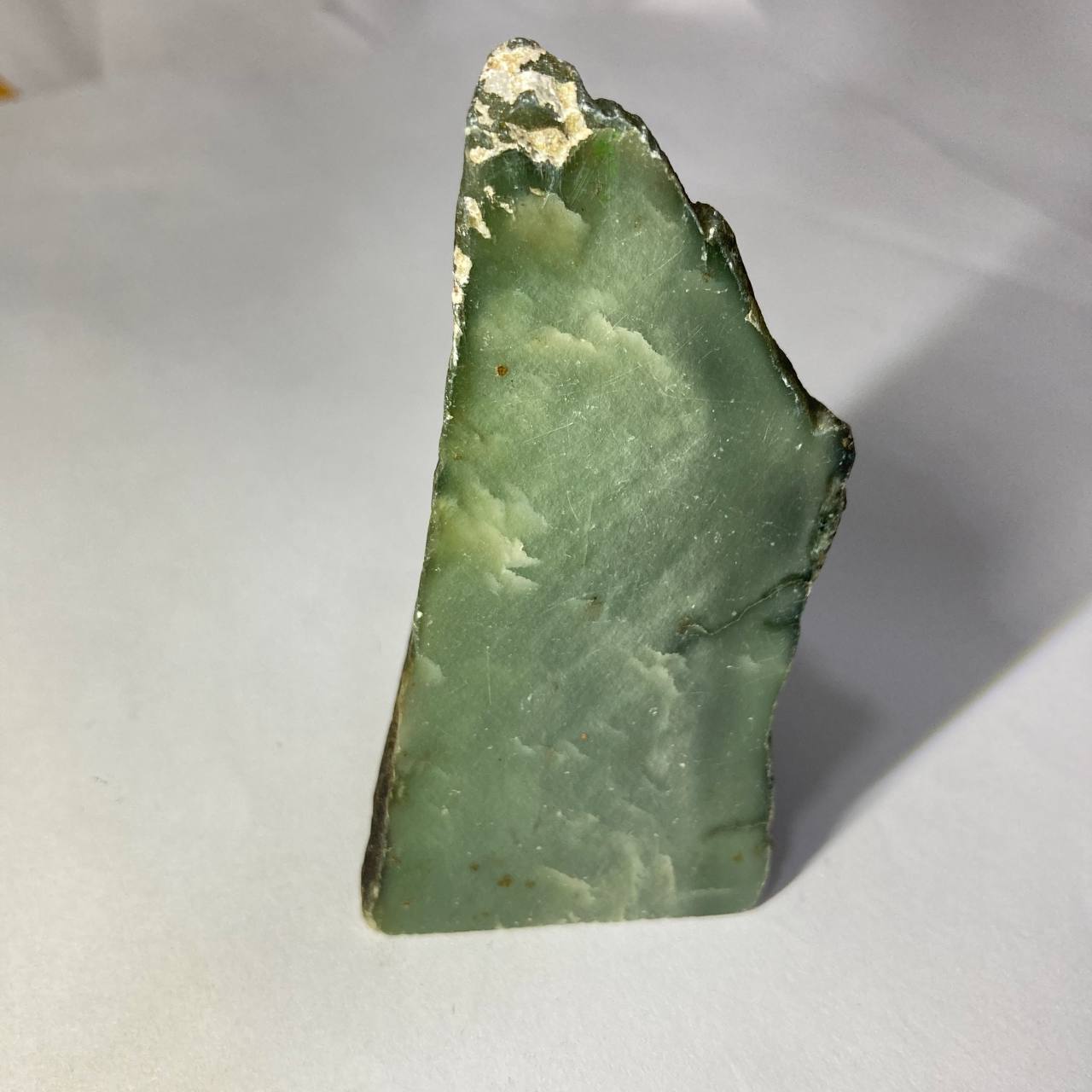 Green mineral specimen on a white background