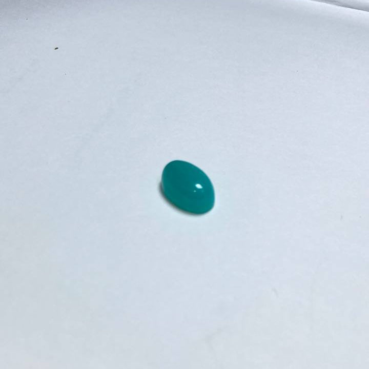 Single green gemstone on a white background