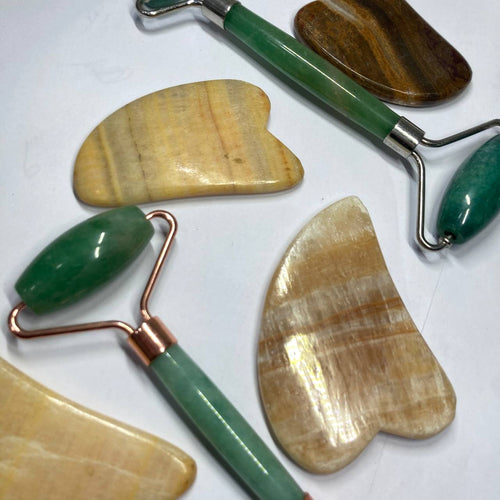 Set of stone tools with green and copper handles on a white background