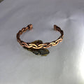 Copper bracelet on a white background