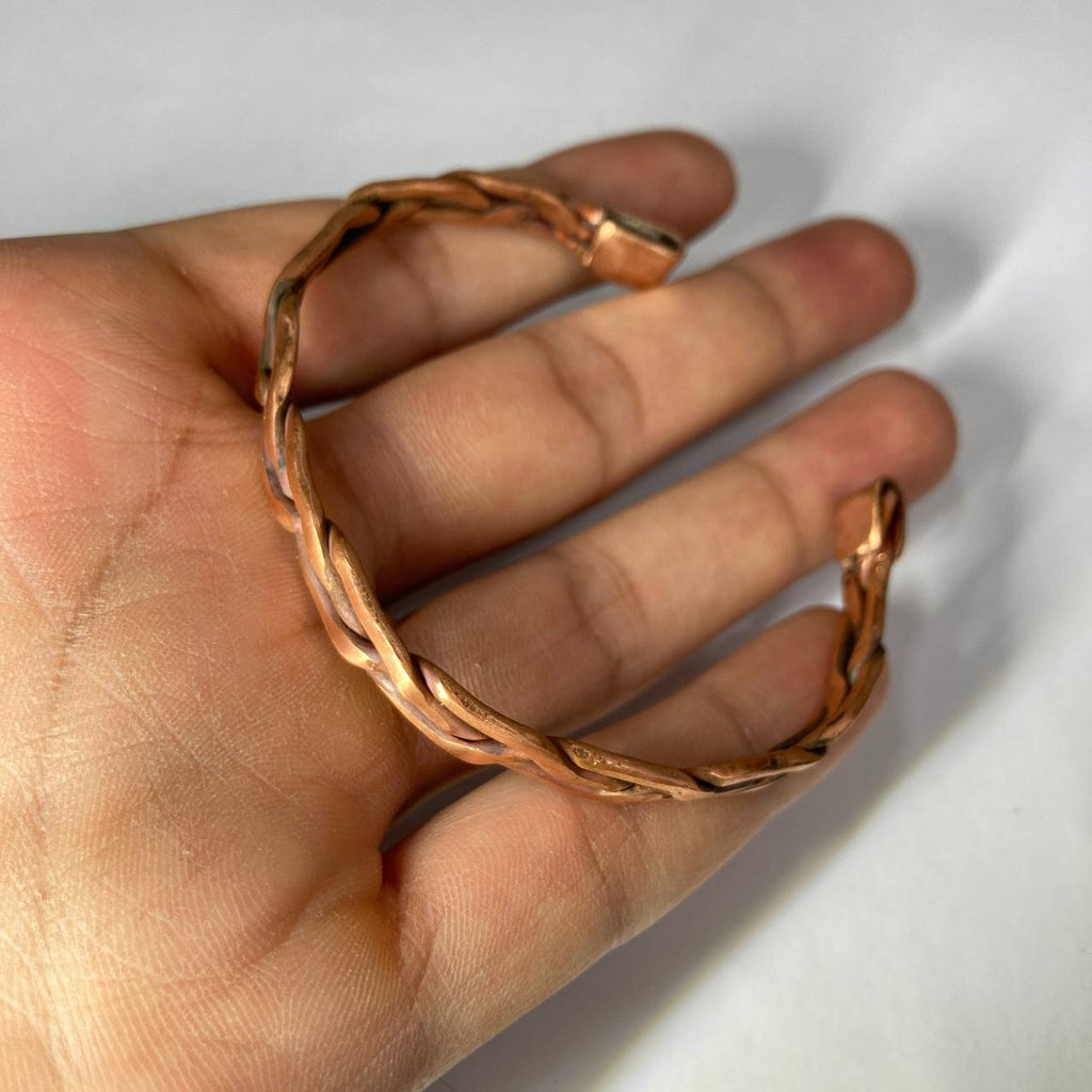 Copper ring on a hand against a white background